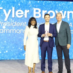 Tyler Brown, , Vice President, Government Affairs, Sammons Financial Group, (center) receives the the IRI Rising Star Award from Wayne, Chopus, President & CEO, IRI, and Shani Armon, Chief Operating Officer, IRI.
